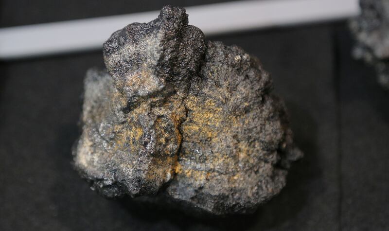 A polymetallic nodule from the seabed is displayed at a mining convention in Toronto, Canada, on March 4, 2019.