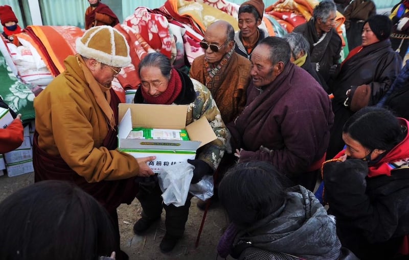 Tulku Hungkar Dorje distributes clothes and blankets to Tibetan people in an undated photo.