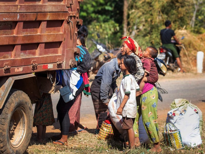 Refugees wait by a truck in Phekhon Township, southern Shan State, Myanmar, Feb. 18, 2022.
